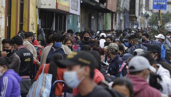 Streets vendors and shoppers wearing masks amid the spread of the new coronavirus fill a street in Lima, Peru, Monday, June 8, 2020, despite an extension of the state of emergency and quarantine, to June 30, to curb the spread of COVID-19. (AP Photo/Martin Mejia)
