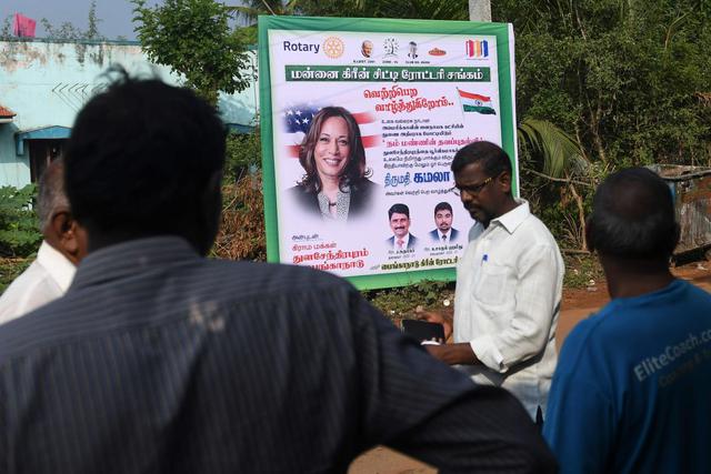 Los residentes pasan junto a un cartel de la candidata demócrata a la vicepresidencia de Estados Unidos, Kamala Harris, en Thulasendrapuram, India. (AFP / Arun SANKAR).