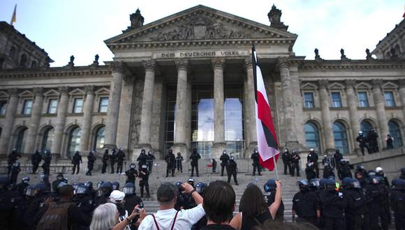 Manifestantes frente al edificio del Reichstag después de que un grupo intentara subir las escaleras del emblemático lugar. (Foto: EFE / Clemens Bilan)