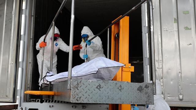 QUITO, ECUADOR - APRIL 22: Health workers move the body of a deceased patient to one of the five refrigerated containers ready to stock up to 200 bodies of victims of COVID-19 each at Parque Bicentenario on April 22, 2020 in Quito, Ecuador. Ecuador is the second worst-hit country in the region, only after Brazil. According to Johns Hopkins University, Ecuador has confirmed over 10,400 positive cases of COVID-19 and 530 deaths. Local authorities believe the numbers are higher due to low diagnoses and testings. (Photo by Franklin Jacome/Agencia Press South/Getty Images)