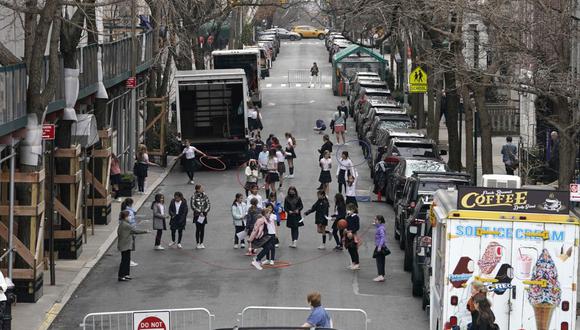 Los niños juegan a saltar la cuerda en la calle de la Quinta Avenida en la ciudad de Nueva York el 7 de marzo de 2022. (Foto de TIMOTHY A. CLARY / AFP)
