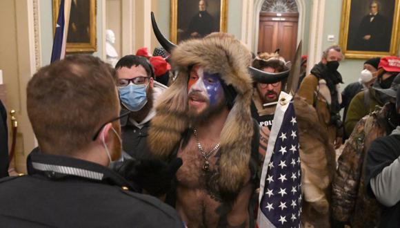 Los partidarios del presidente de los Estados Unidos, Donald Trump, incluido el miembro del grupo conspirativo de QAnon, Jake A, también conocido como Yellowstone Wolf (C), ingresan al Capitolio de los Estados Unidos el 6 de enero de 2021 en Washington, DC. (Saul LOEB / AFP).