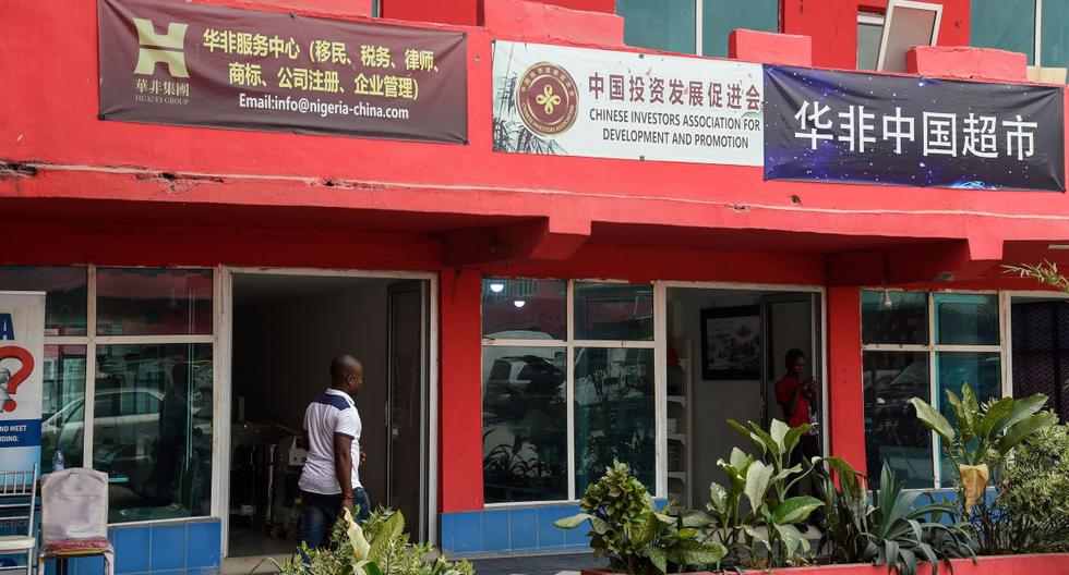 Un hombre pasa por las tiendas vacías en el desierto centro comercial China Commercial City, popularmente llamado "China Town", en Ojota en Lagos, mientras la gente teme contraer el COVID-19, el nuevo coronavirus. (AFP).