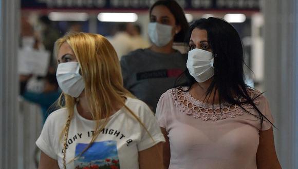 Pasajeros usan mascarillas como medida preventiva contra la propagación del coronavirus COVID-19 en el Aeropuerto Internacional de Tocumen, en la Ciudad de Panamá. (Foto: AFP)