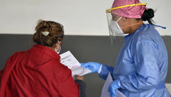 Una mujer recibe los resultados de su prueba de COVID-19 en el estacionamiento del centro comercial Vía Vallejo en la Ciudad de México. (Foto: ALFREDO ESTRELLA / AFP)