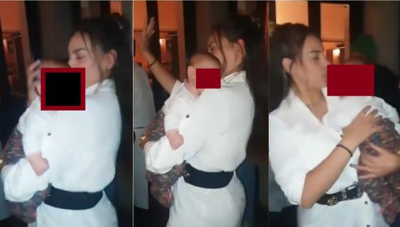 Aída Martínez cargando a su bebé y bailando en un local. | Foto: Instagram.