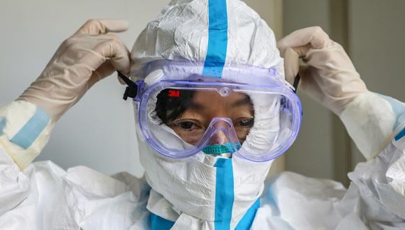 Un trabajador de salud se coloca un traje de seguridad en China, en enero de 2020. (Foto: STR / AFP)