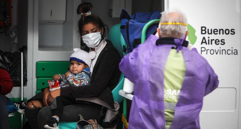 Una mujer con su pequeño hijo es trasladado en una ambulancia luego de dar positivo en un testeo de coronavirus en Villa Azul, este martes, en la Provincia de Buenos Aires (Argentina). EFE/ Juan Ignacio Roncoroni