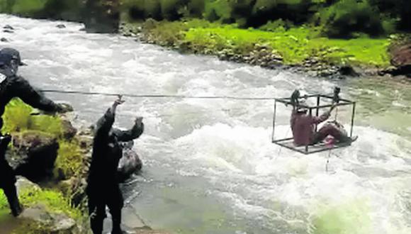 Rescatan a madre e hijo que estaban "suspendidos" sobre río (VIDEO)