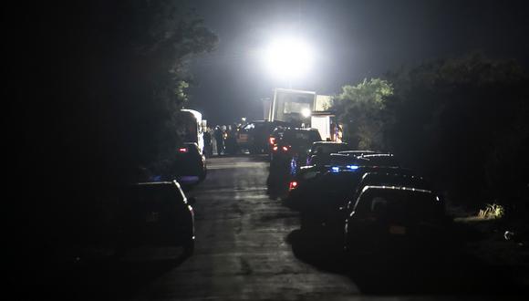 Los vehículos de emergencia se encuentran estacionados en el lugar donde se descubrió un camión con remolque con migrantes dentro de las afueras de San Antonio, Texas, el 27 de junio de 2022. (Foto de Sergio FLORES / AFP)