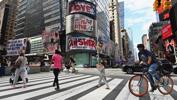 La gente cruza la calle cerca de Time Square el pasado 28 de septiembre de 2020 en la ciudad de Nueva York. En la ciudad las tasas de infección por coronavirus han aumentado a "un ritmo alarmante" en varios vecindarios, particularmente entre la comunidad judía ortodoxa en Brooklyn. (Angela Weiss / AFP)