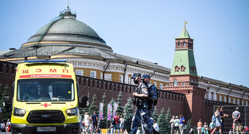 Los militares de la Guardia Nacional de Rusia caminan por la Plaza Roja frente a una ambulancia en el centro de Moscú el 18 de junio de 2021, en medio de la crisis relacionada con la pandemia de coronavirus. (Foto de Alexander NEMENOV / AFP).