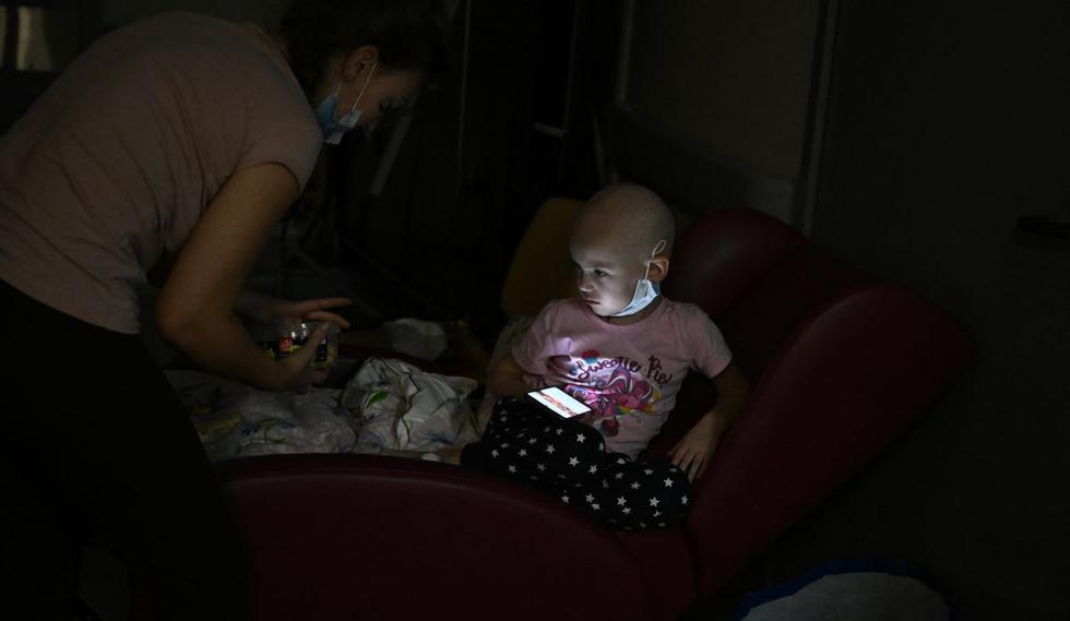 Un niño con cáncer interactúa con su enfermera mientras que está en un refugio antibombas en el hospital de oncología de Kiev. (Foto de Aris Messinis / AFP)
