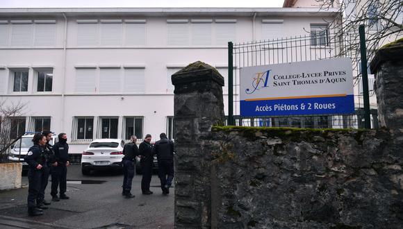 Oficiales de policía se paran en la entrada de la escuela secundaria Saint-Thomas d Aquin, donde un maestro murió después de ser apuñalado por un alumno, en Saint-Jean-de-Luz, suroeste de Francia, el 22 de febrero de 2023. (Foto de GAIZKA IROZ / AFP)