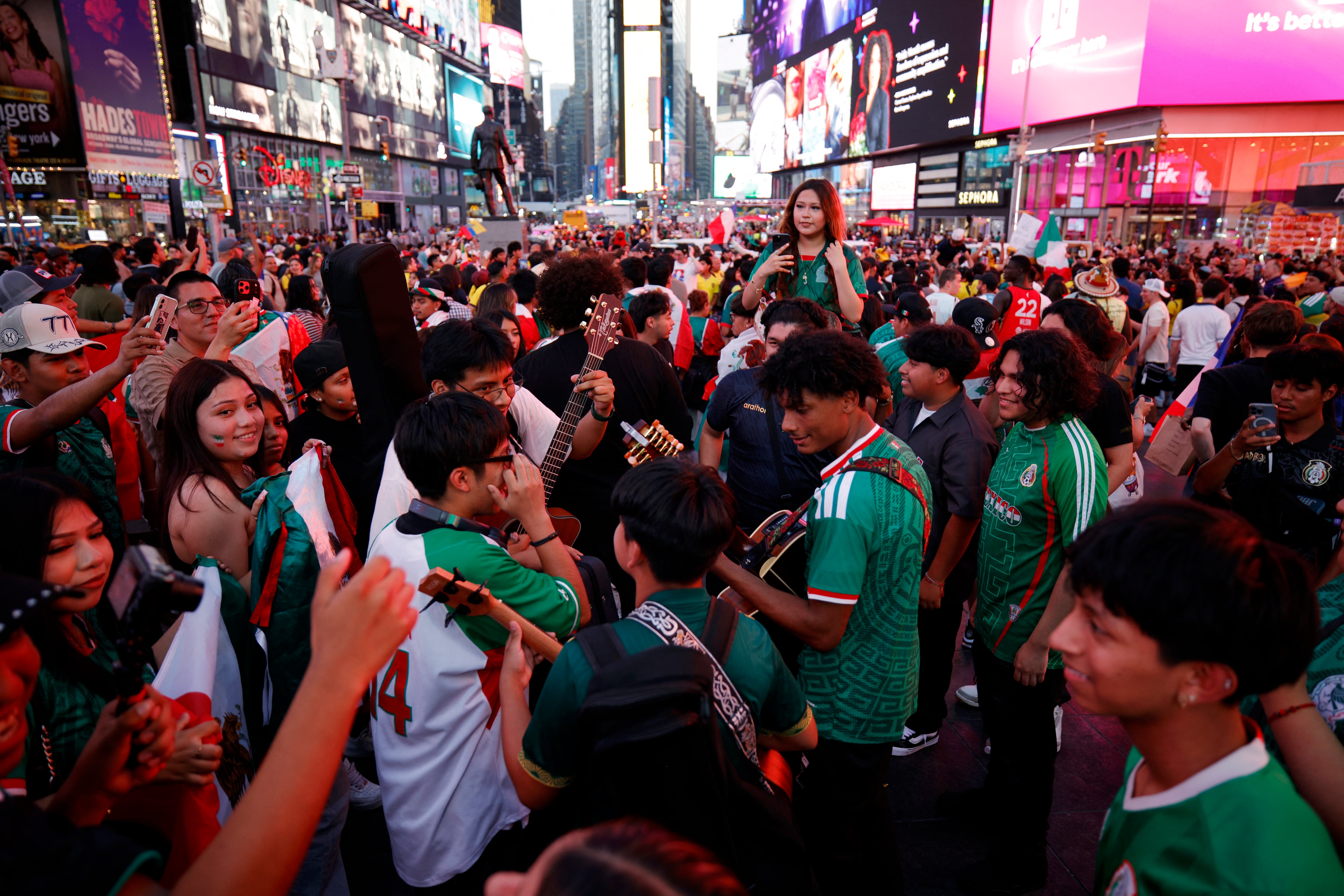 Mexico fans gather to watch the 2026 World Cup match between Mexico and Ecuador in Times Square in New York, on June 30, 2026. (Photo by Leonardo MUNOZ / AFP)
