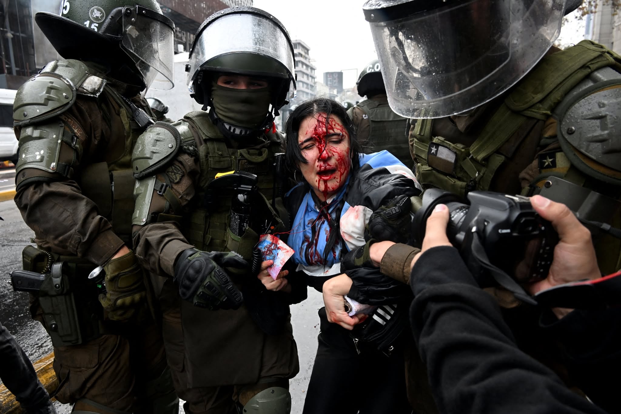 Riot police arrest a demonstator during a students march against social cuts pushed through by Chile's President Jose Antonio Kast in Santiago, on June 3, 2026. (Photo by RODRIGO ARANGUA / AFP)