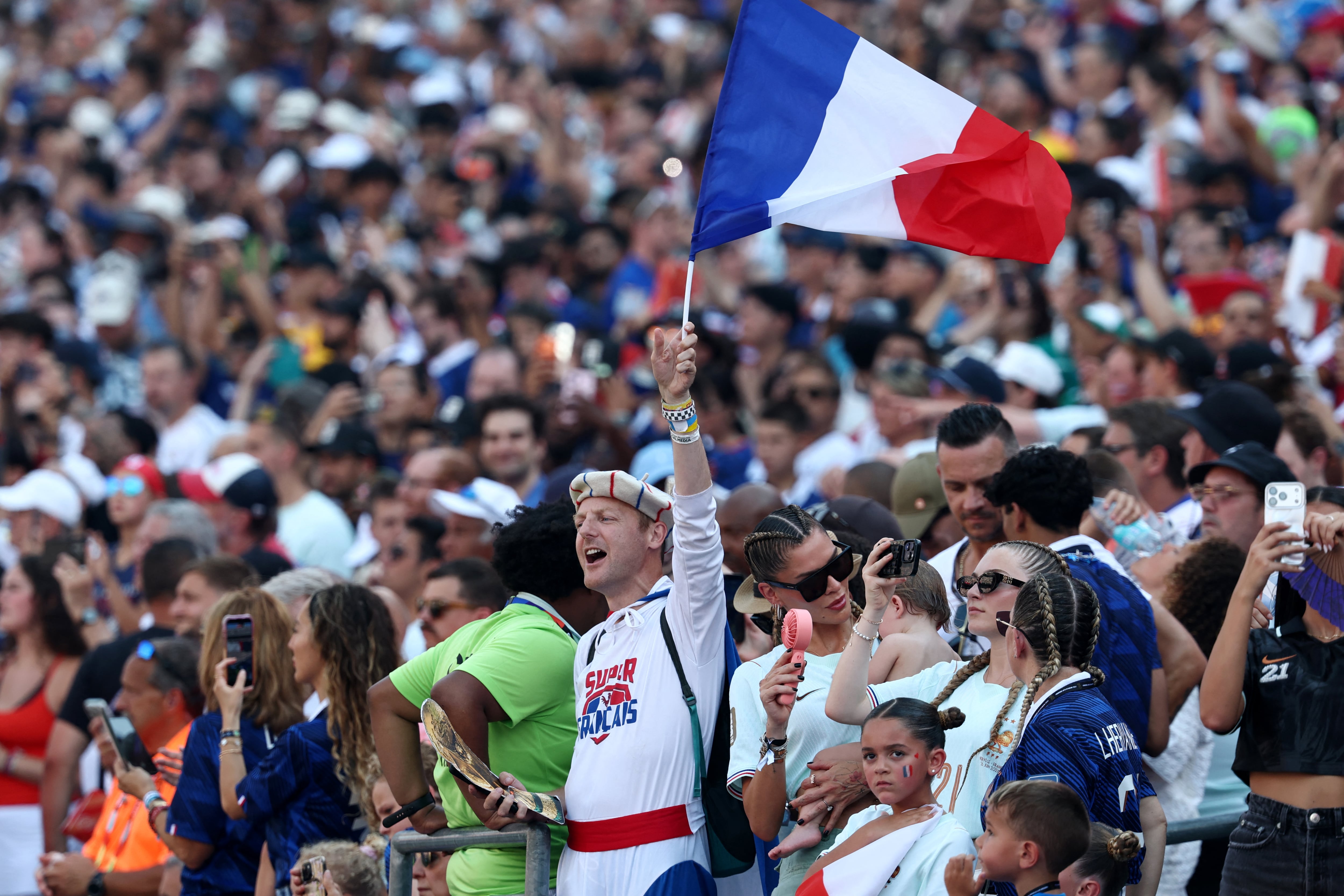 A France's fan waves a flag at the end of the 2026 World Cup round of 16 football match between Paraguay and France at the Philadelphia Stadium in Philadelphia on July 4, 2026. (Photo by FRANCK FIFE / AFP)