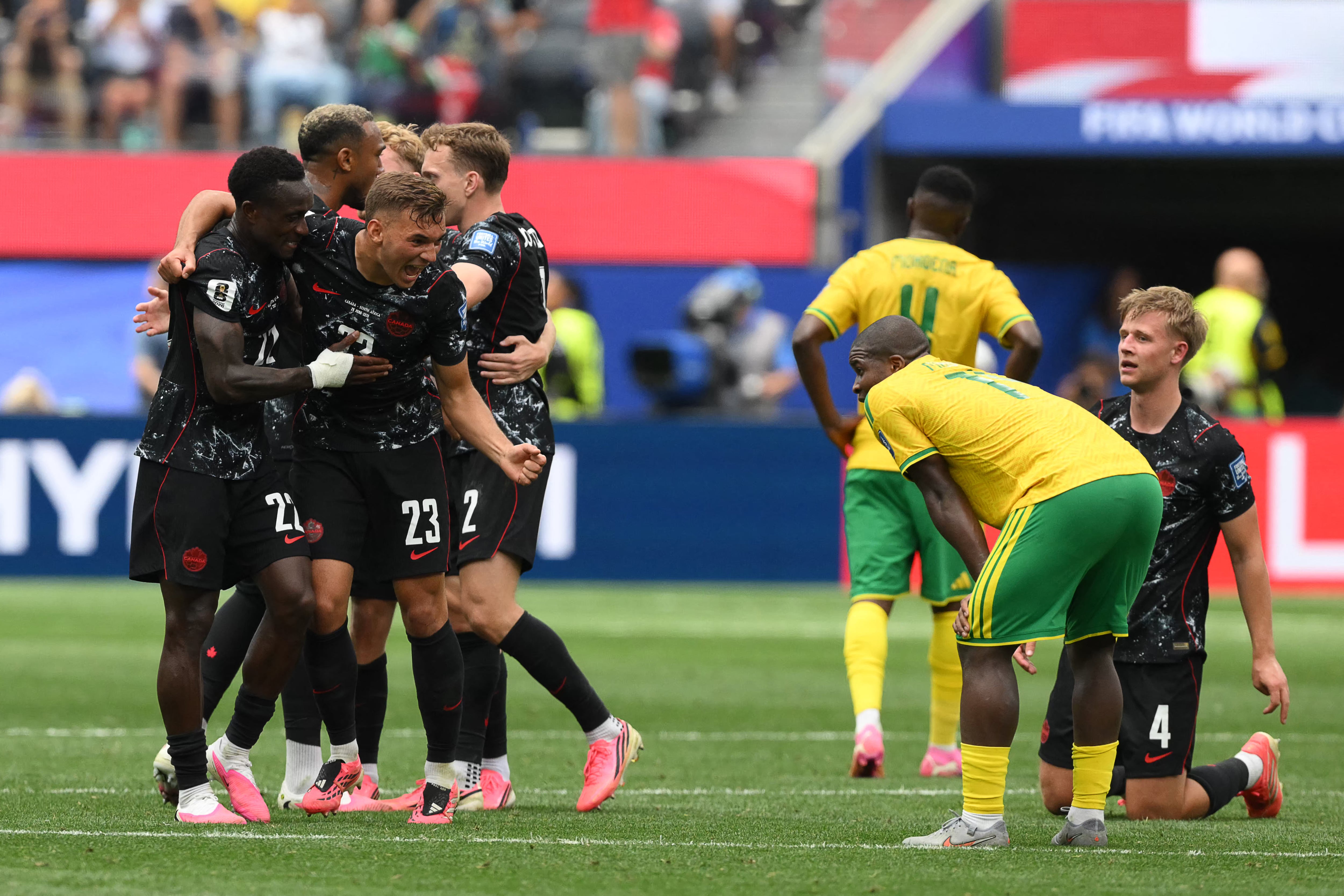 Canada's defender #22 Richie Laryea and defender #23 Niko Sigur celebrate after winning the 2026 World Cup round of 32 football match between South Africa and Canada at the Los Angeles Stadium in Inglewood on June 28, 2026. (Photo by Patrick T. Fallon / AFP)