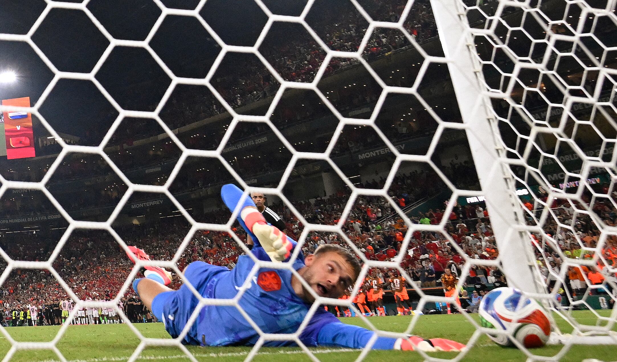 Netherlands goalkeeper #01 Bart Verbruggen concedes a penalty goal by Morocco forward #09 Soufiane Rahimi during the penalty shootout of the 2026 World Cup round of 32 football match between the Netherlands and Morocco at the Monterrey Stadium in Guadalupe on June 29, 2026. (Photo by Alfredo ESTRELLA / AFP)