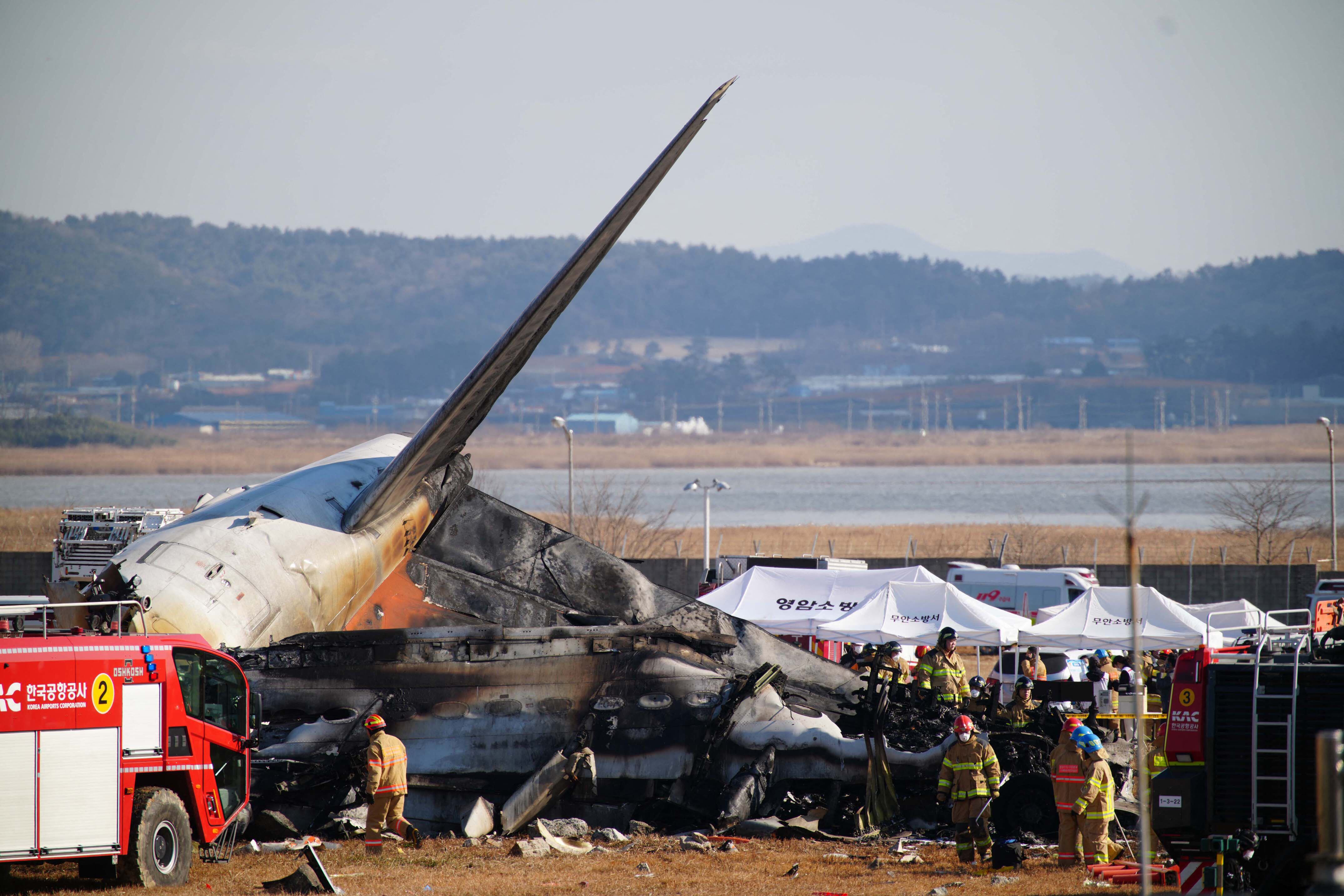 Los bomberos han confirmado que el balance final del accidente sufrido hoy domingo por el vuelo 7C2216 de la surcoreana Jeju Air, que estalló tras salirse de pista y chocar contra un muro en el aeropuerto de Muan. (Foto de YONHAP / AFP).