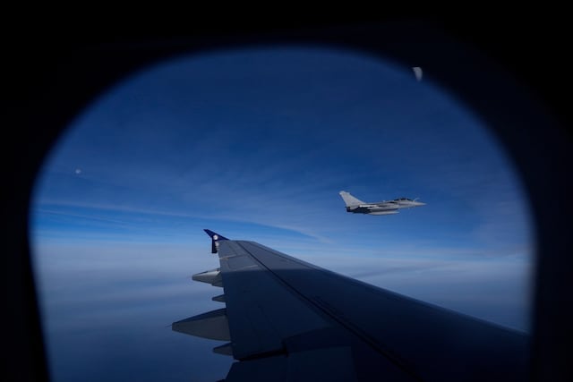 A French Air Force Dassault Rafale C fighter jet is seen through a window of the aircraft carrying Pope Leo XIV from Lourdes to Metz on the last day of his four-day visit to France, on September 28, 2026. (Photo by Gregorio Borgia / POOL / AFP)