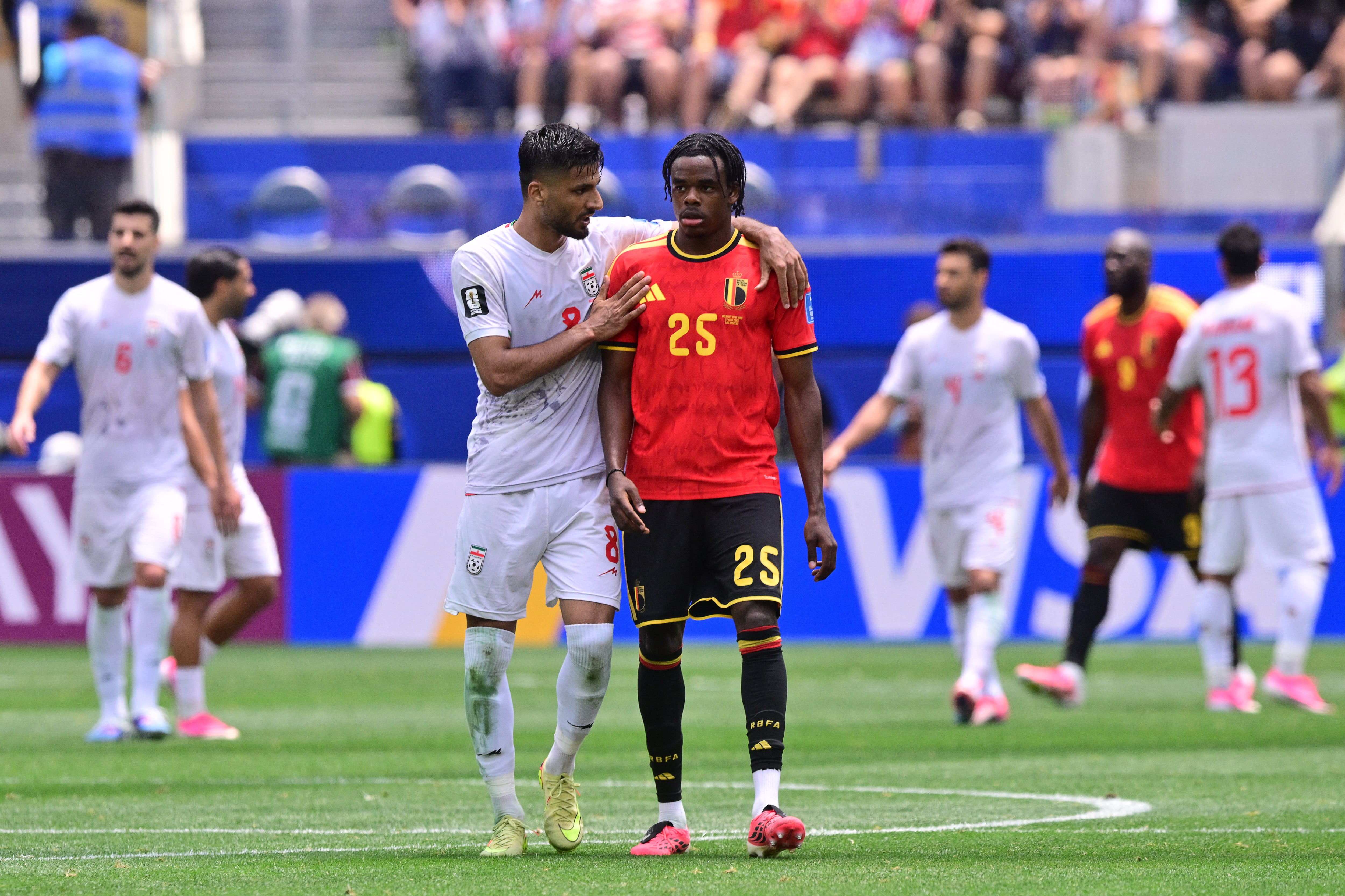 Iran's midfielder #08 Mohammad Mohebbi chats with Belgium's defender #25 Nathan Ngoy during the 2026 World Cup Group G football match between Belgium and Iran at the Los Angeles Stadium in Inglewood on June 21, 2026. (Photo by Frederic J. Brown / AFP)