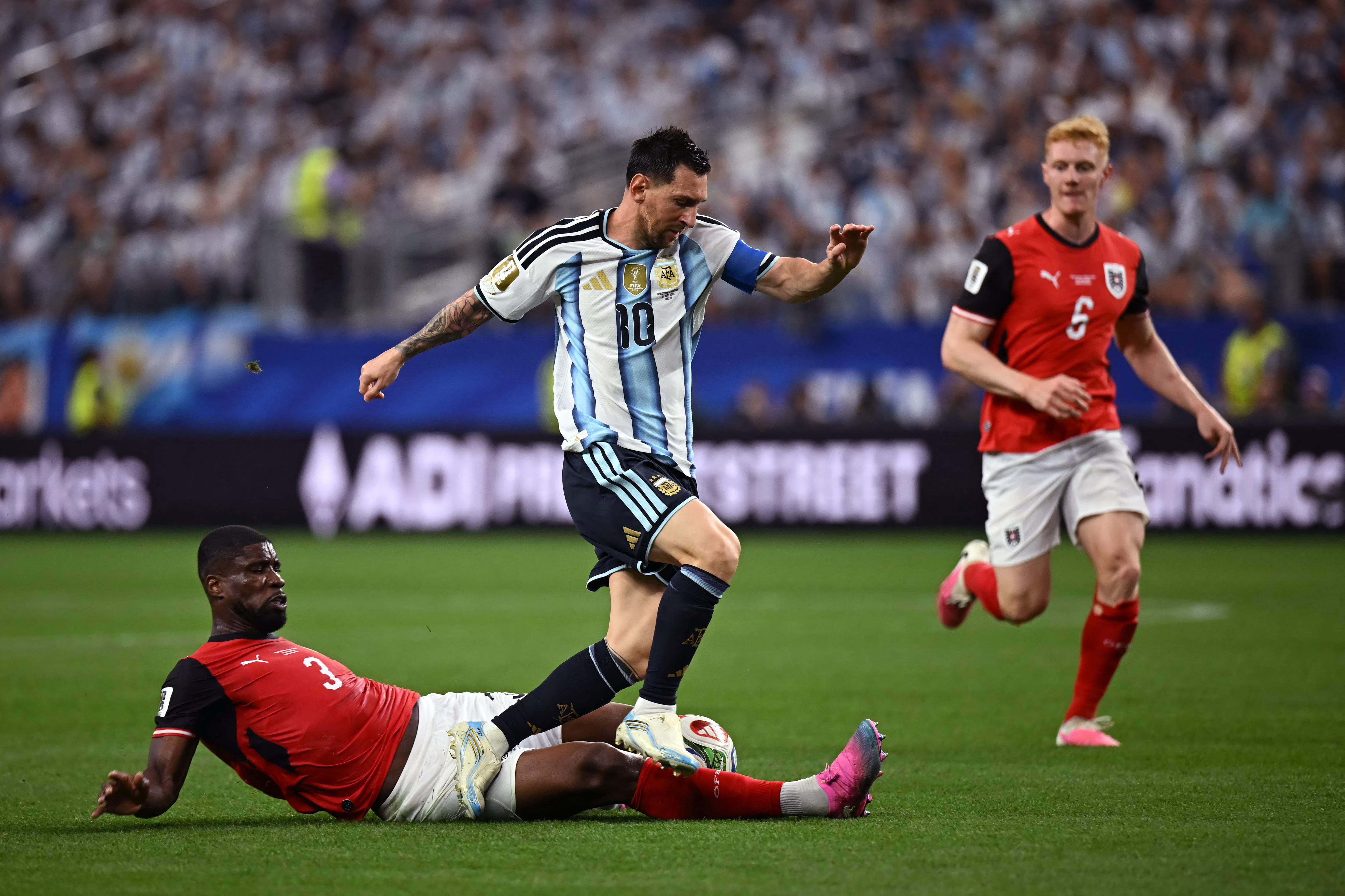 Argentina's forward #10 Lionel Messi (R) fights for the ball with Austria's defender #03 Kevin Danso (L) during the 2026 World Cup Group J football match between Argentina and Austria at the Dallas Stadium in Arlington on June 22, 2026. (Photo by Paul ELLIS / AFP)