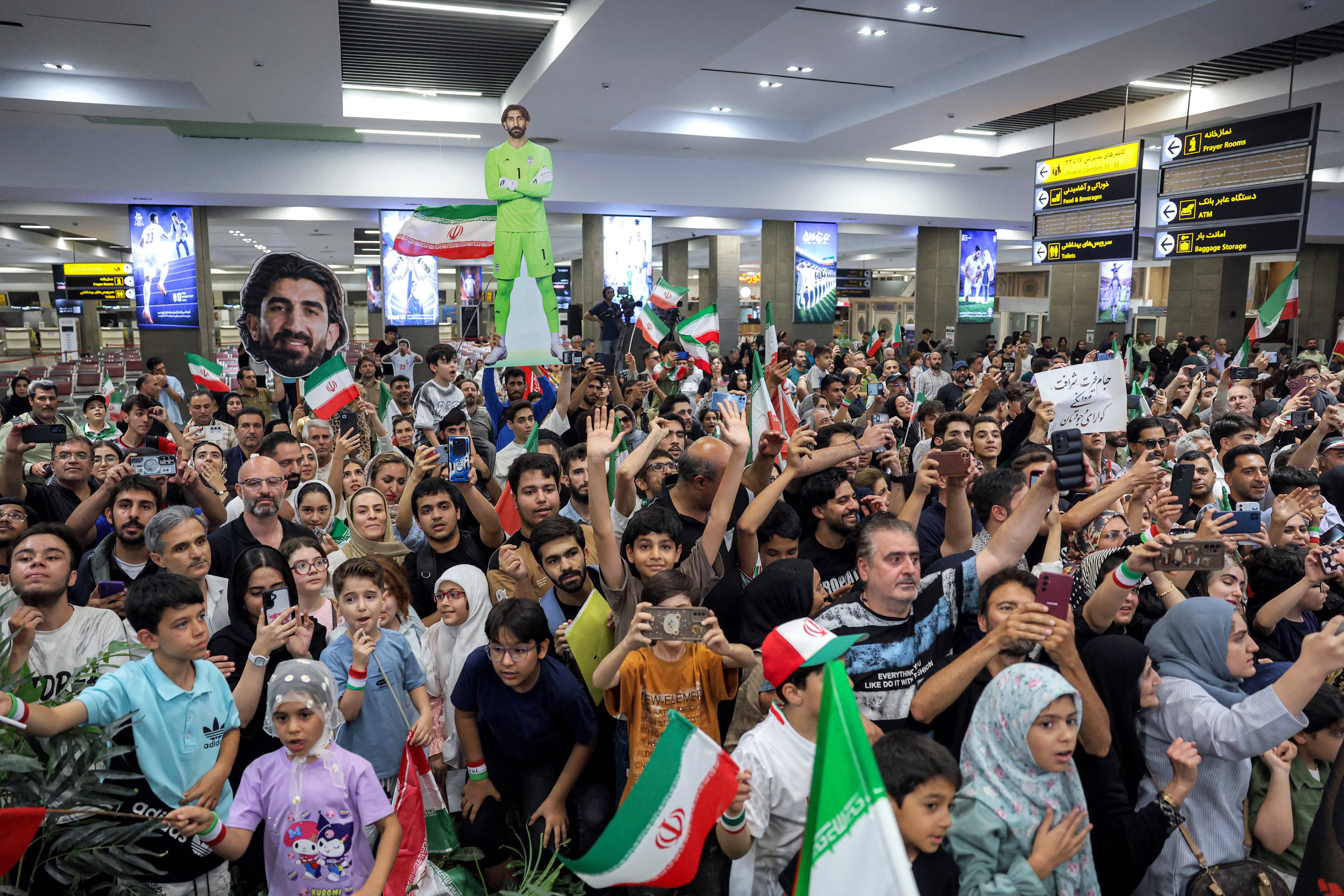 Iranian football fans gather at Tehran's Mehrabad International Airport to receive the men's national football team upon their return from the 2026 FIFA World Cup on July 1, 2026. (Photo by AFP)