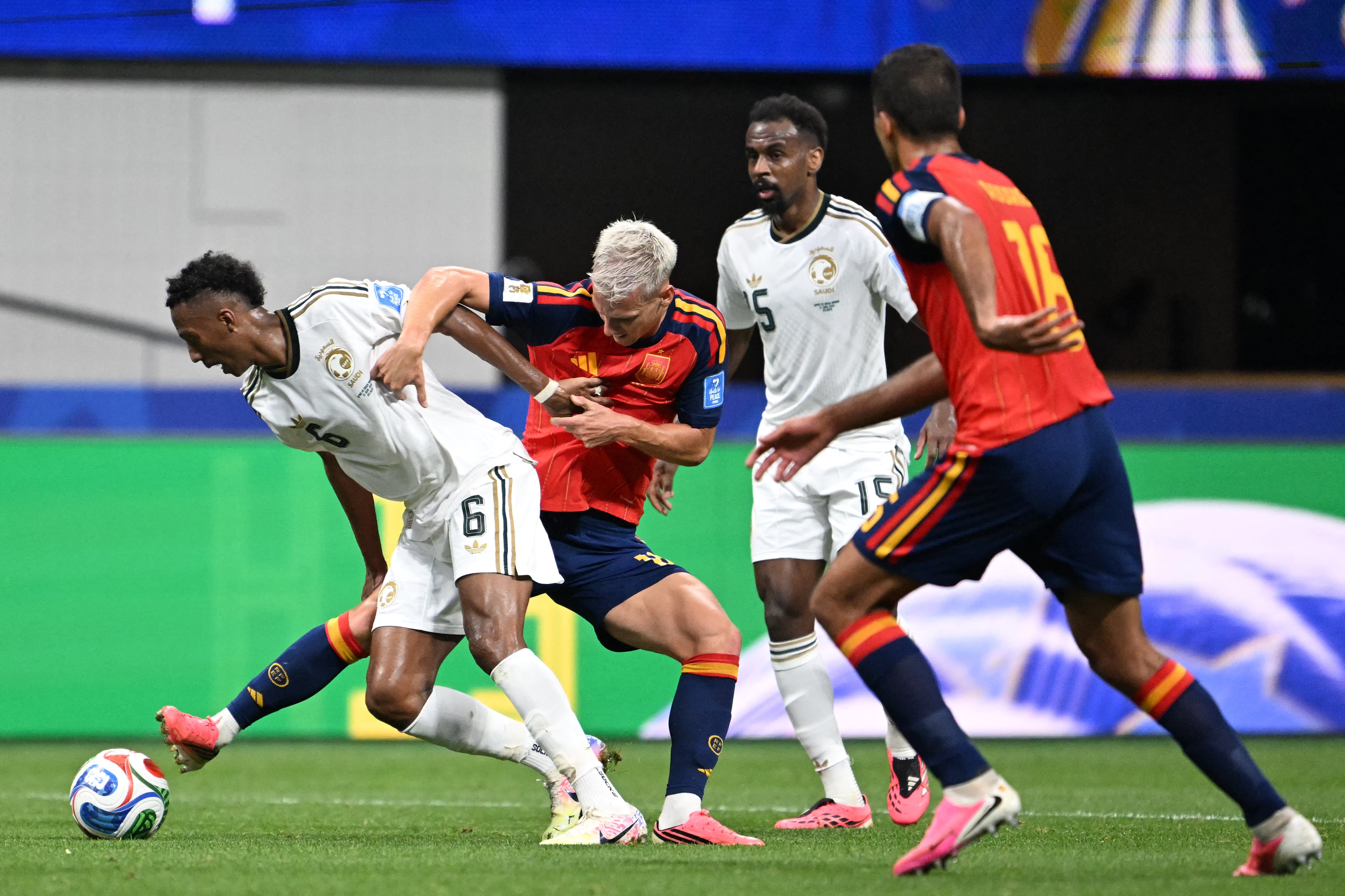 Saudi Arabia's midfielder #06 Nasser Al-Dawsari (L) fights for the ball with Spain's forward #10 Dani Olmo (2nd L) during the 2026 World Cup Group H football match between Spain and Saudi Arabia at the Atlanta Stadium in Atlanta on June 21, 2026. (Photo by ROBERTO SCHMIDT / AFP)