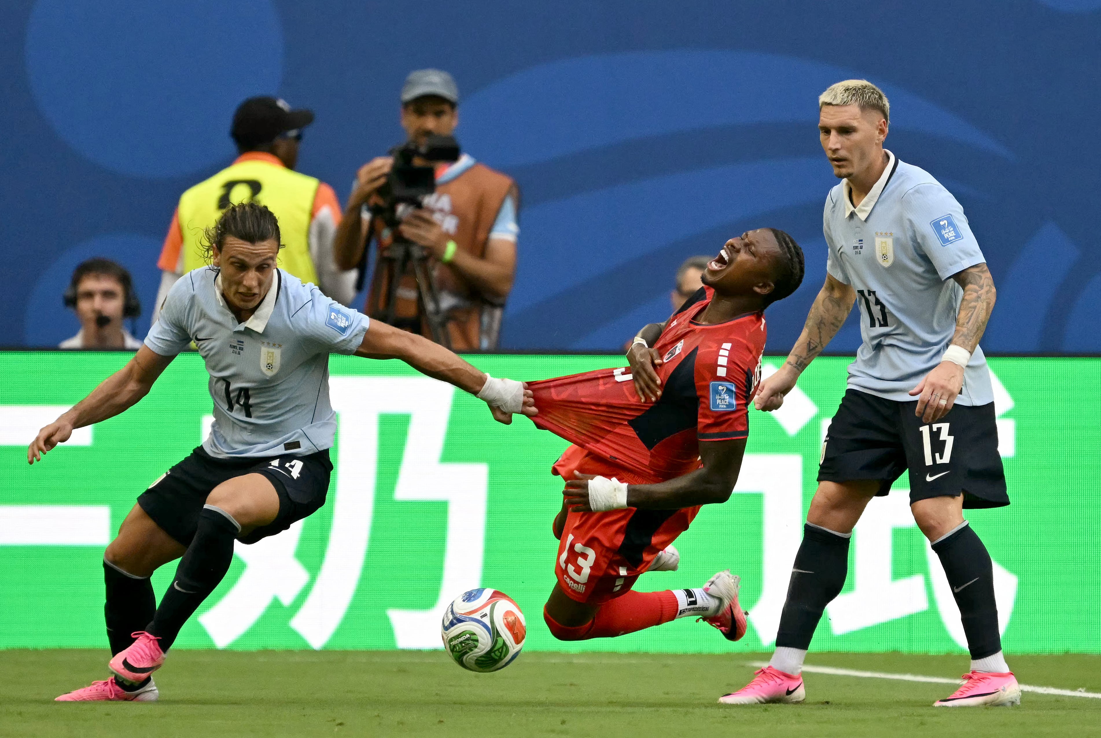 Cape Verde's defender #13 Sidney Lopes Cabral, Uruguay's forward #14 Agustin Canobbio and defender #13 Guillermo Varela fight for the ball during the 2026 World Cup Group H football match between Uruguay and Cape Verde at the Miami Stadium in Miami Gardens on June 21, 2026. (Photo by CHANDAN KHANNA / AFP)