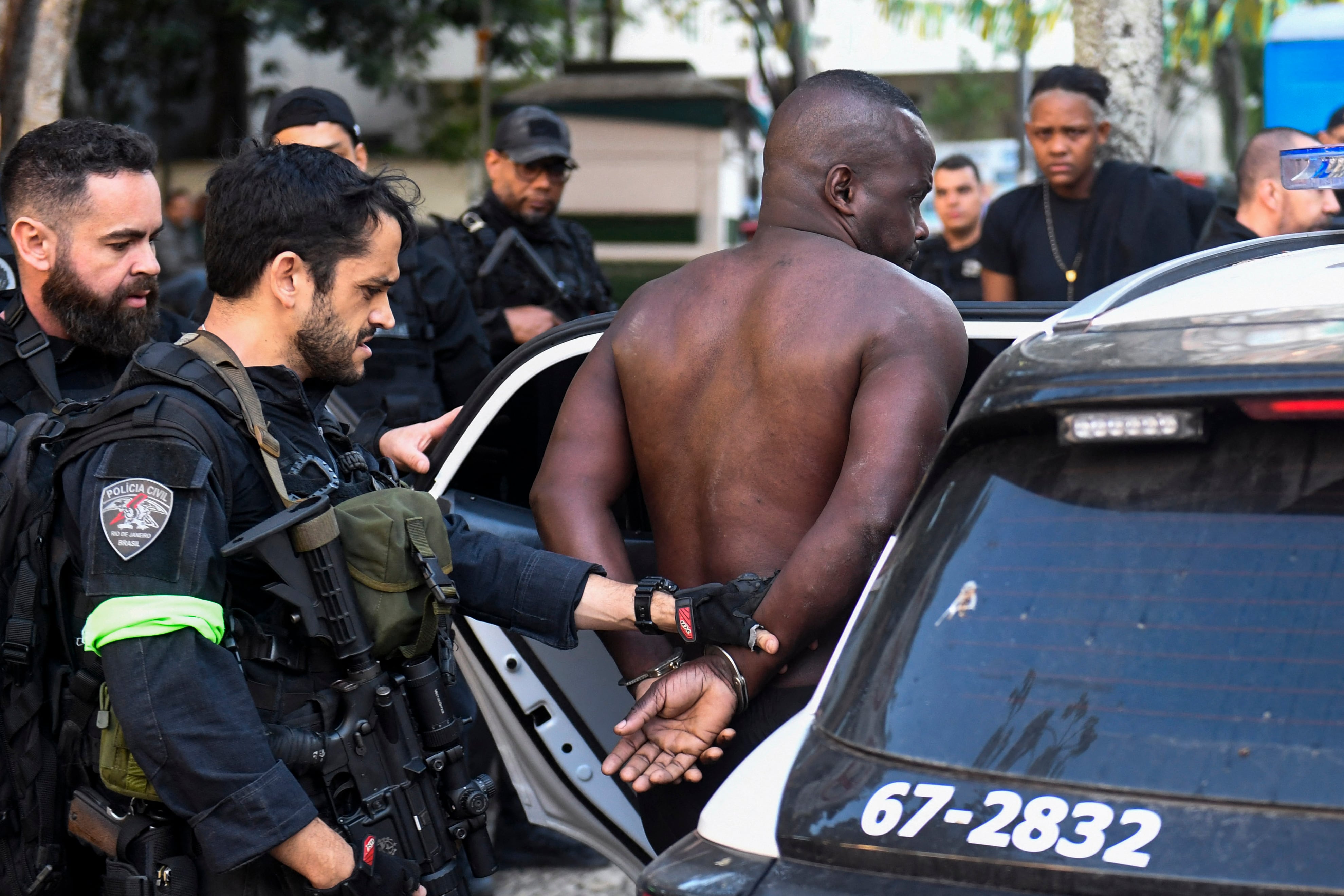 Brazilian Special Police forces arrest a suspect during the Operation Containment at the Santa Marta favela, in Rio de Janeiro, Brazil, on June 23, 2026. The operation targets alleged members linked to the Comando Vermelho drug trafficking organization as authorities seek to contain the gang's territorial expansion and dismantle its criminal infrastructure. (Photo by Daniel RAMALHO / AFP)