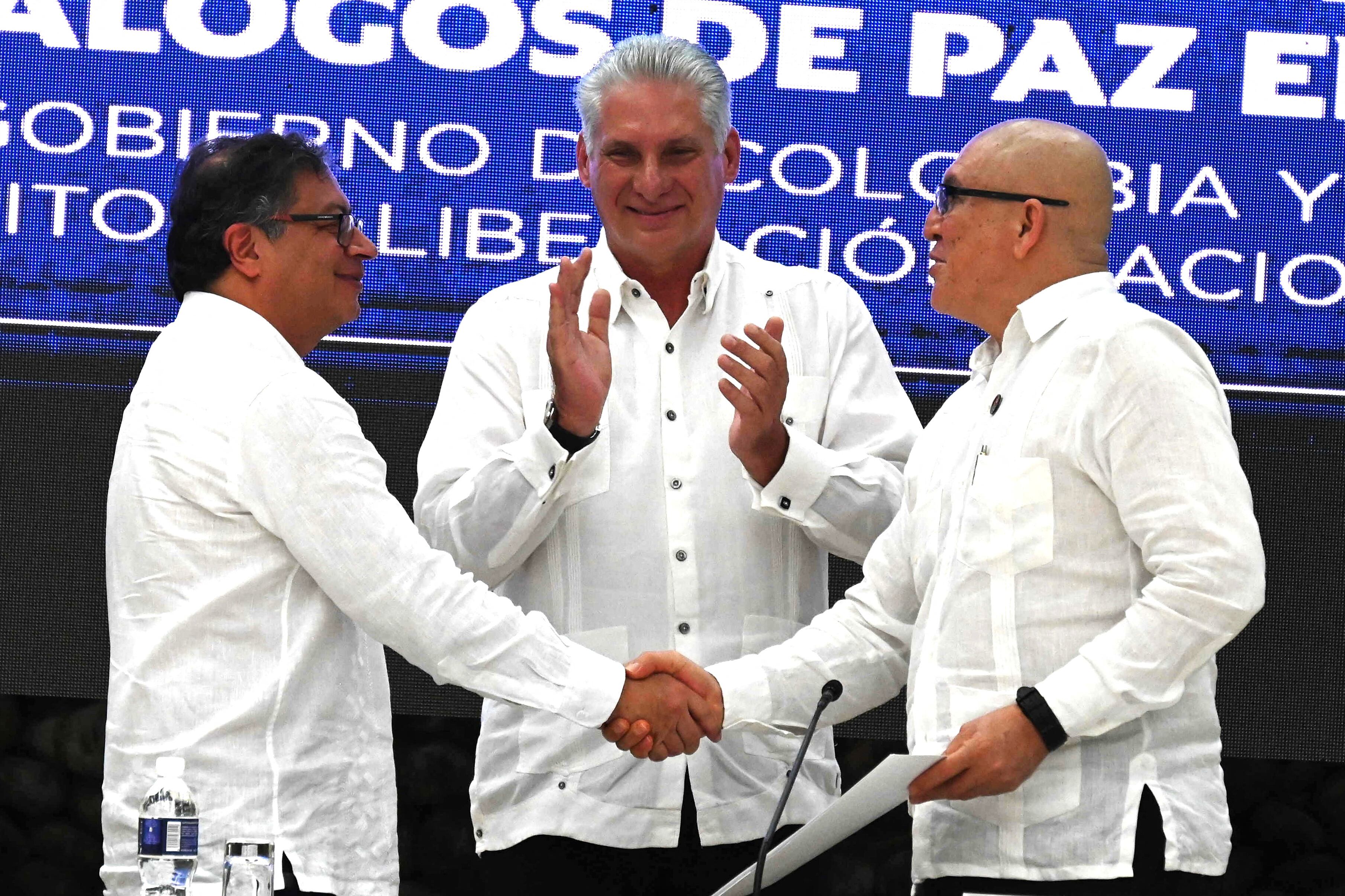 El presidente colombiano Gustavo Petro (L) y el Primer Comandante Guerrillero del ELN Antonio García (R) se dan la mano junto al presidente cubano Miguel Díaz-Canel (C) al final del cierre de la Tercera Ronda de Negociaciones de Paz entre el Gobierno colombiano y el Nacional Ejército de Liberación (ELN) en El Laguito en La Habana, el 9 de junio de 2023. (Foto de YAMIL LAGE / AFP)