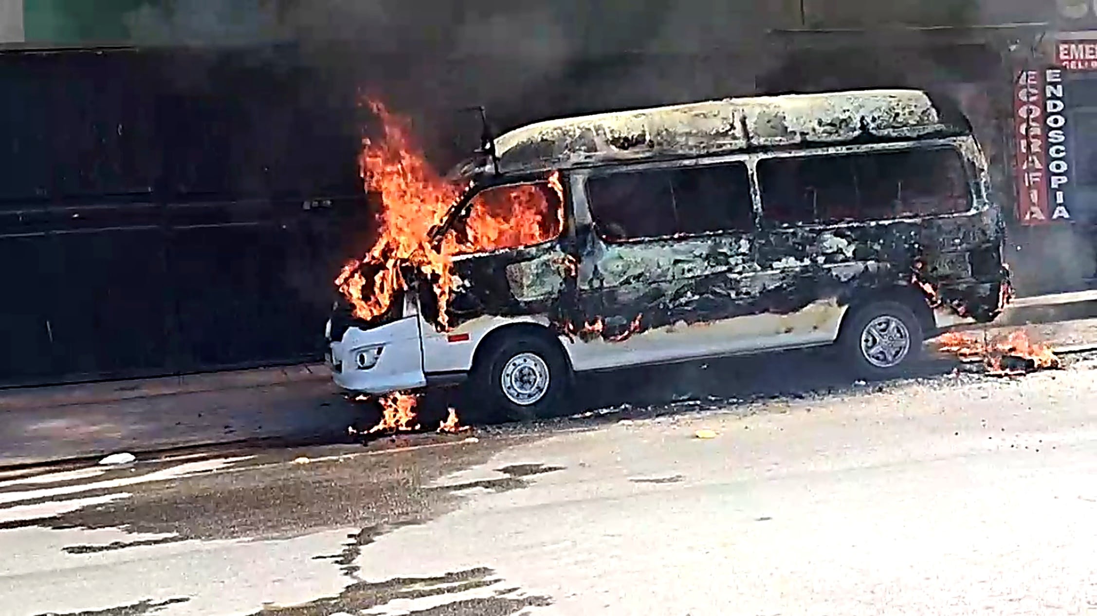 Combi se incendia en plena vía pública en el distrito de Majes, Arequipa. (Foto: Captura de video Canal 10 Rimelsa/Mejorada con IA)
