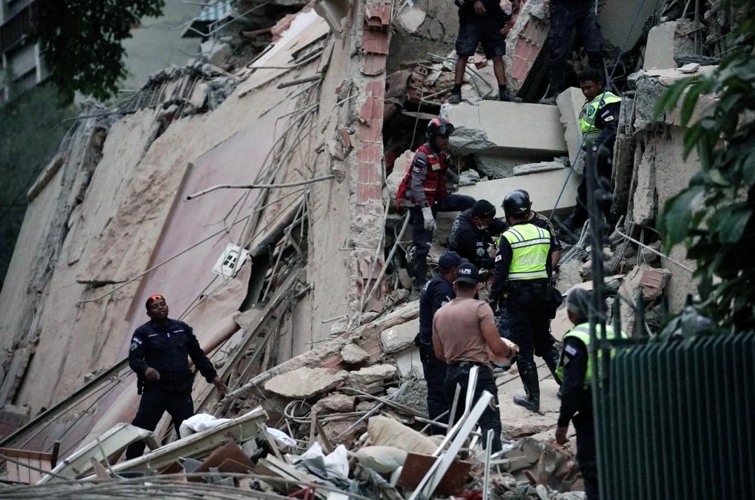 Equipos de rescate buscan víctimas entre los escombros de un edificio colapsado. (Foto de Manaure Quintero / AFP).