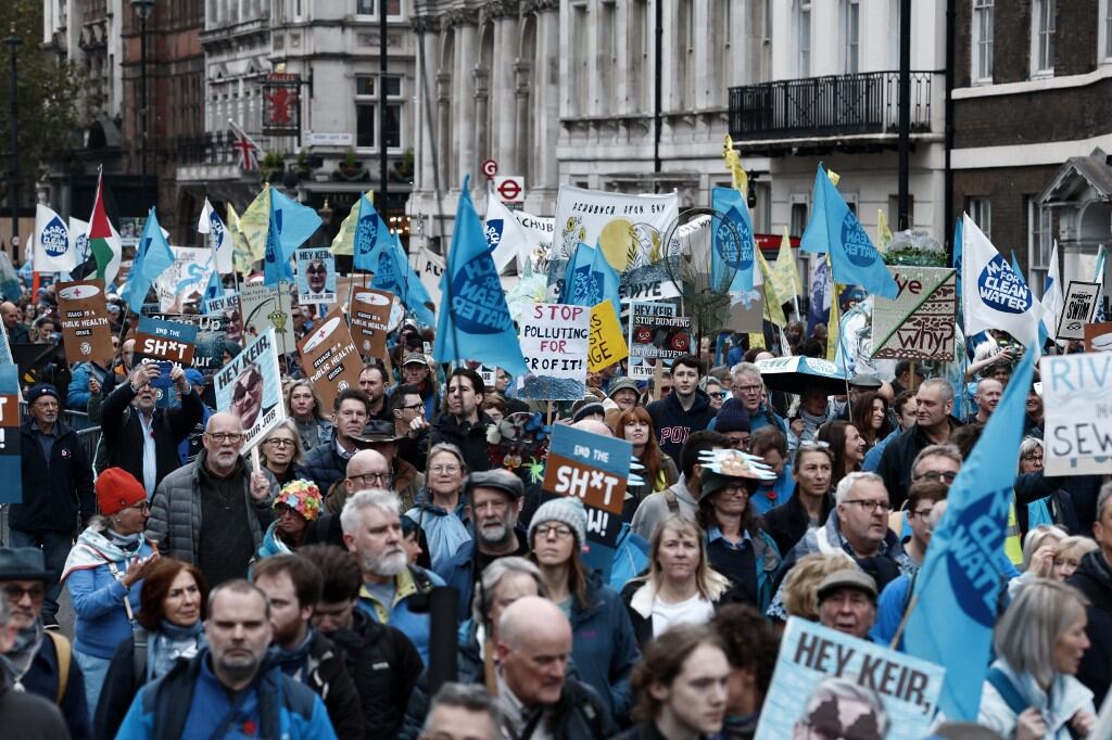 People hold placards as they take part in a "March for Clean Water" in London on November 3, 2024, calling for the government to "stop the poisoning of Britain's waters". (Photo by BENJAMIN CREMEL / AFP)