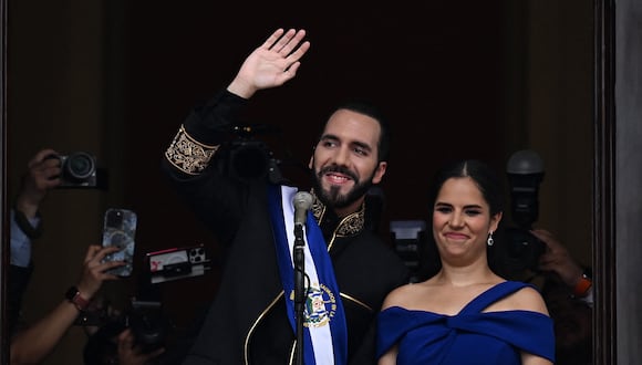 El presidente de El Salvador, Nayib Bukele, saluda a sus seguidores junto a su esposa Gabriela Rodríguez después de prestar juramento en el Palacio Nacional en el centro de San Salvador el 1 de junio de 2024. (Foto de Marvin Recinos / AFP)
