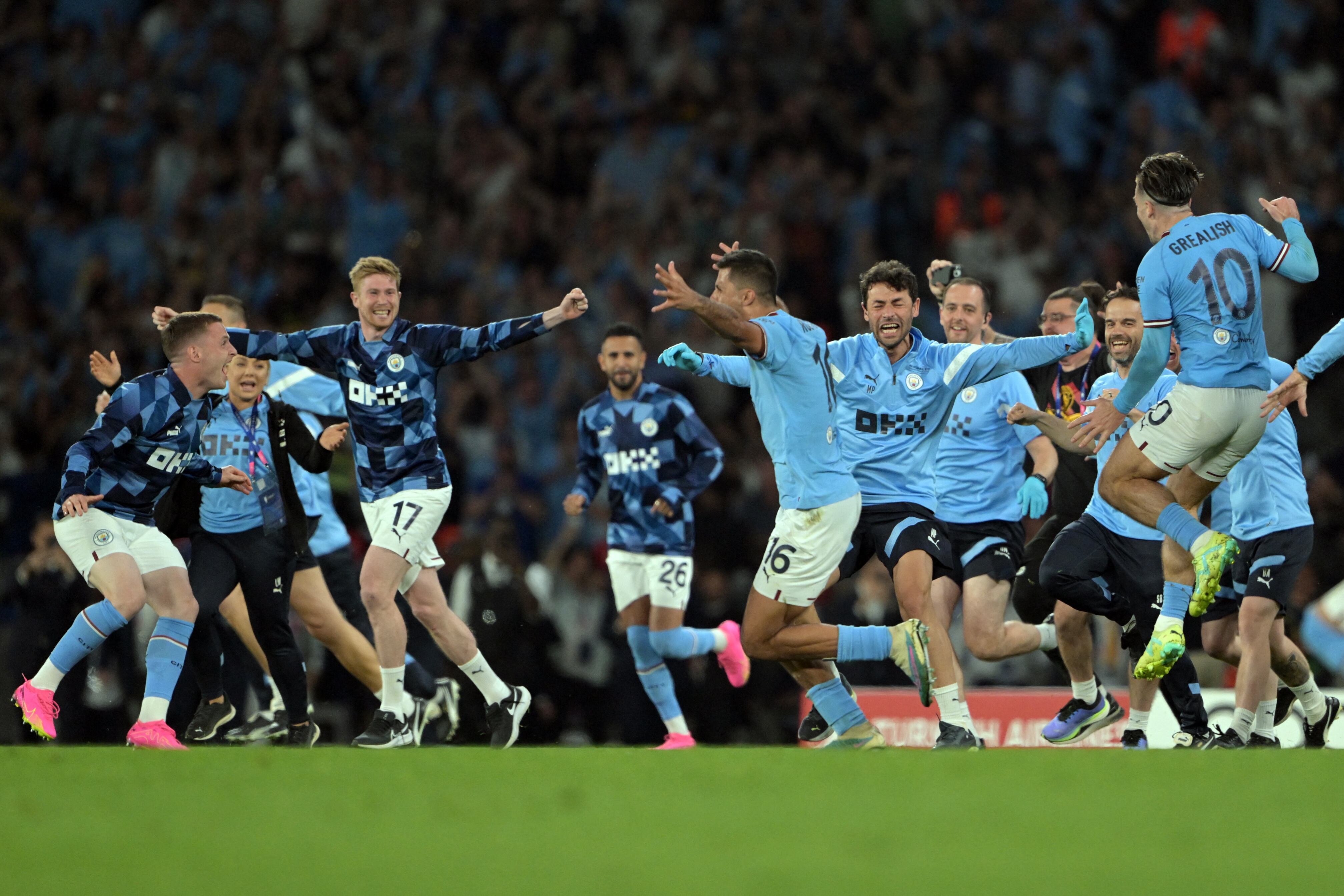 Manchester City players celebrate winning the UEFA Champions League final football match between Inter Milan and Manchester City at the Ataturk Olympic Stadium in Istanbul, on June 10, 2023. Manchester City won the match 1-0. (Photo by OZAN KOSE / AFP)