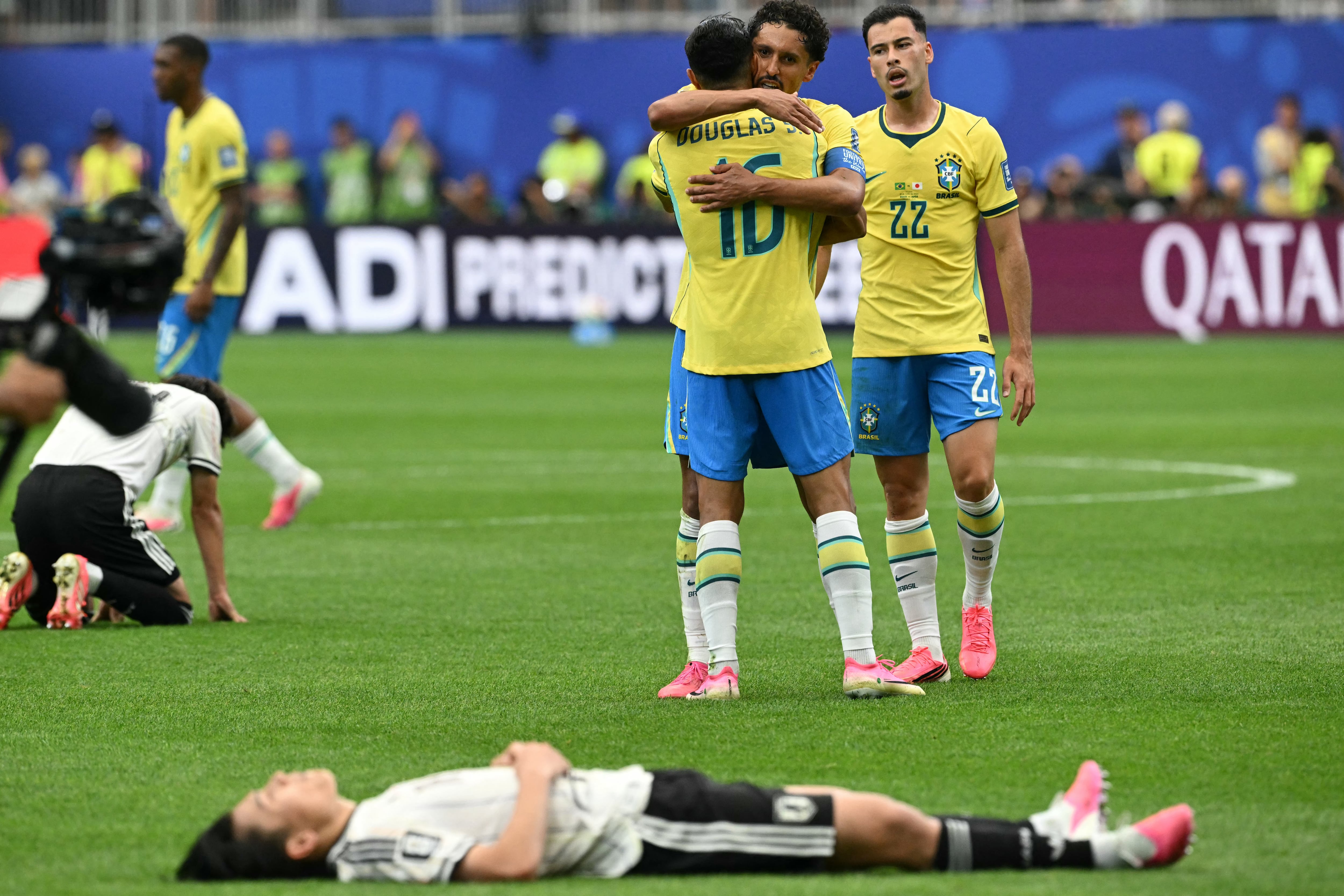 Brazil's defender #16 Douglas Santos (standing 3rdR) celebrates with Brazil's defender #04 Marquinhos (standing 2ndR) at the end of the 2026 World Cup round of 32 football match between Brazil and Japan at the Houston Stadium in Houston on June 29, 2026. (Photo by RONALDO SCHEMIDT / AFP)