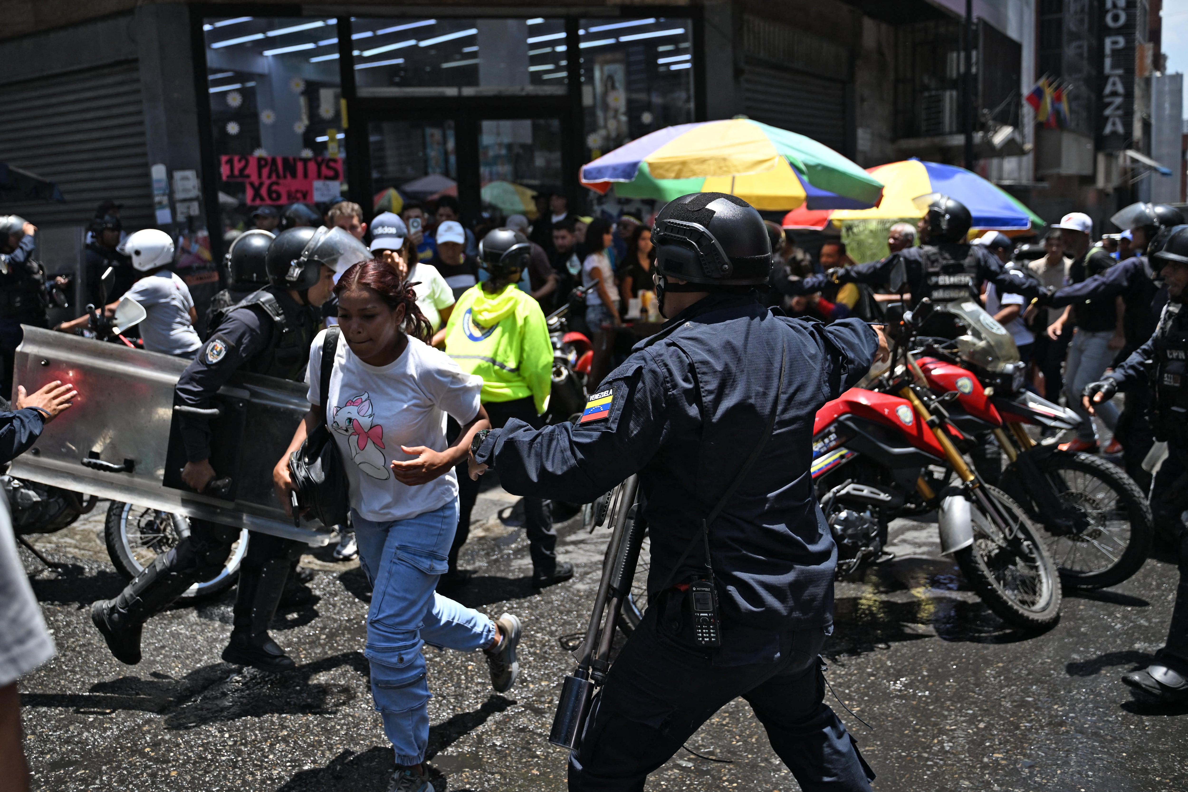 Police officers are deployed as opponents to the government of Venezuelan interim President Delcy Rodriguez demonstrate in demand of salary and pension raises in Caracas on April 8, 2026. (Photo by Juan BARRETO / AFP)