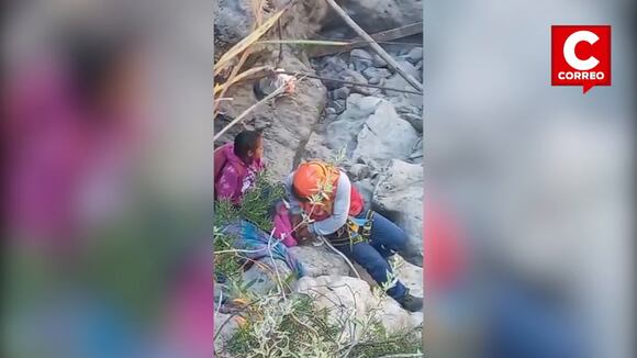 Niños cruzan el río Mantaro cargados por trabajadores